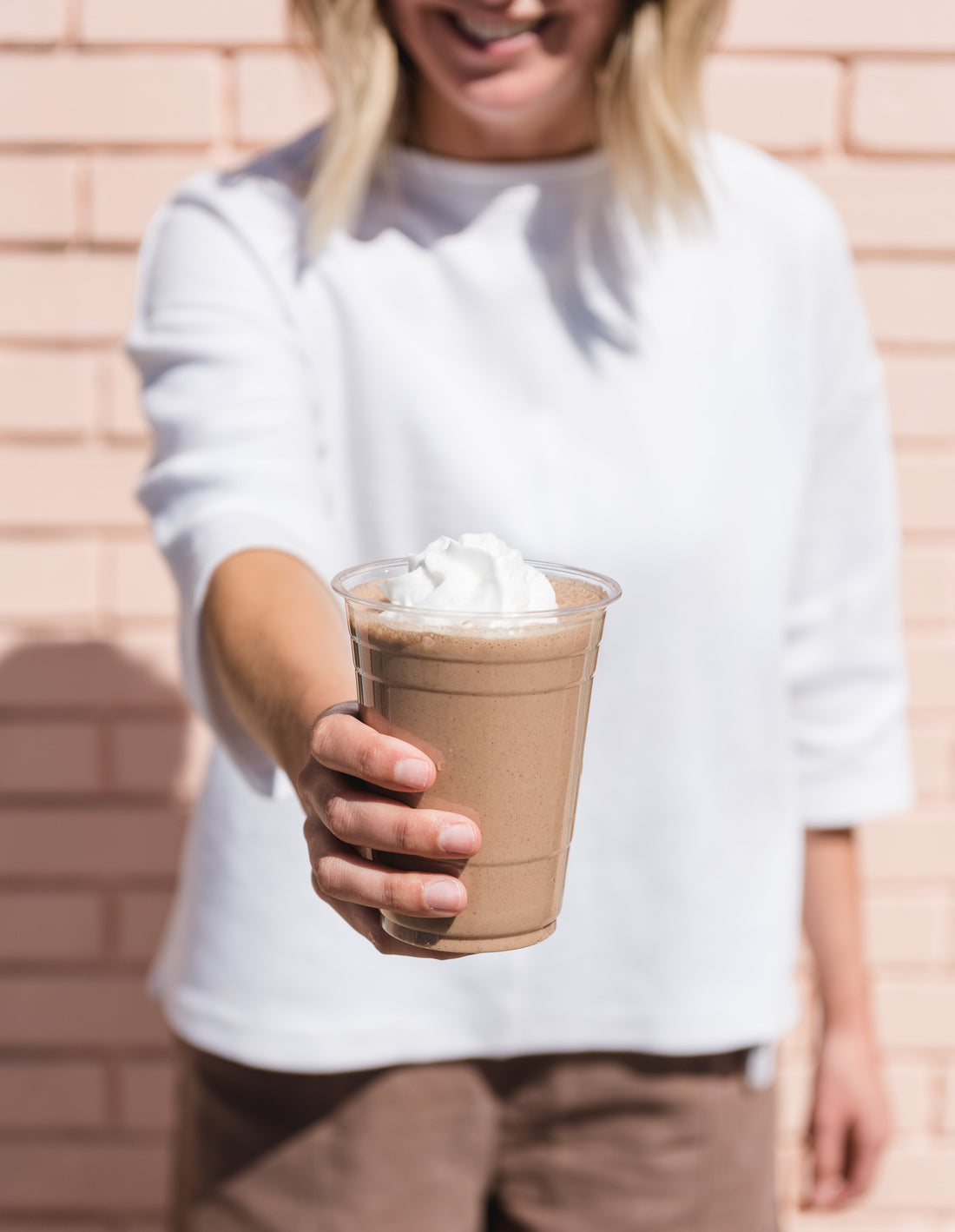 woman holding smoothie
